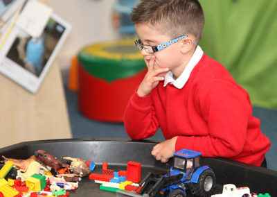 Boy playing with cars and building blocks